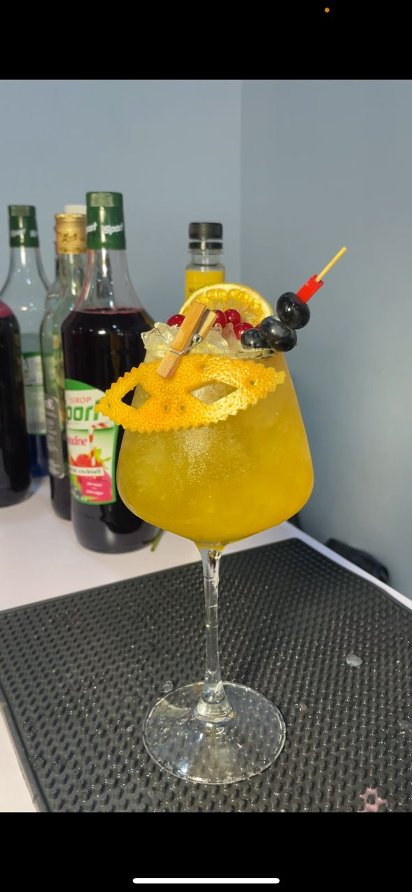 Highbridge Mix orange cocktail with decorative citrus garnish